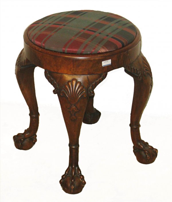 Four Legged Stool: An 18" Georgian style walnut four legged stool featuring carved ball and claw feet.