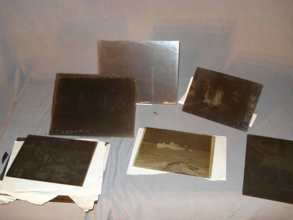 Photos on Glass: About twenty photos on glass negatives in various sizes (although all are about 5" X 6") showing mostly people and buildings. Judging from the garb, may date to the Edwardian era, about 1900.