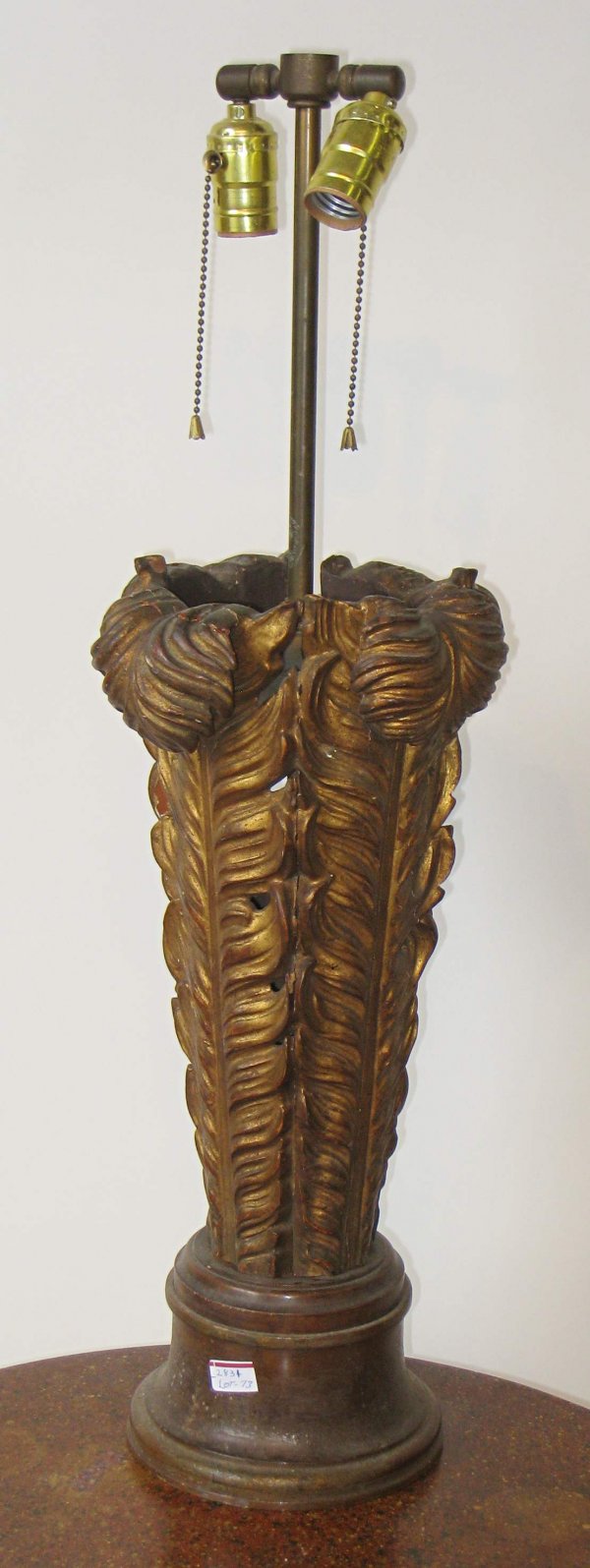 Carved Lamp: A 29" two bulb lamp whose base is four joined feathers, carved from wood and gilded.
