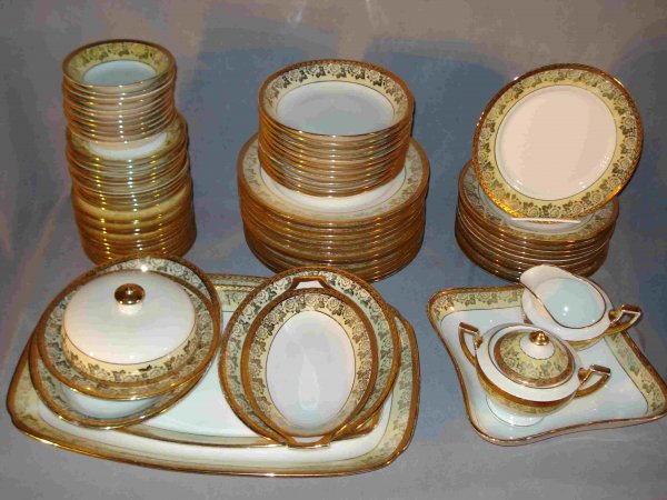 Porcelain Set: A 22K gold decorated porcelain set marked "Thomas Bavaria" and overstamped. Service for 12, but now with at least 10 settings: 10" platters, 8" platters, lidded casserole, soup bowls, smaller bowls, b