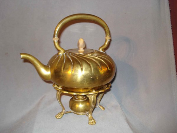 Gorham arts and crafts tea pot: A lidded copper or brass and wood tea pot with the stand and warmer, both stamped Gorham with an anchor hallmark and with V44 and 54. Previously silver plated.