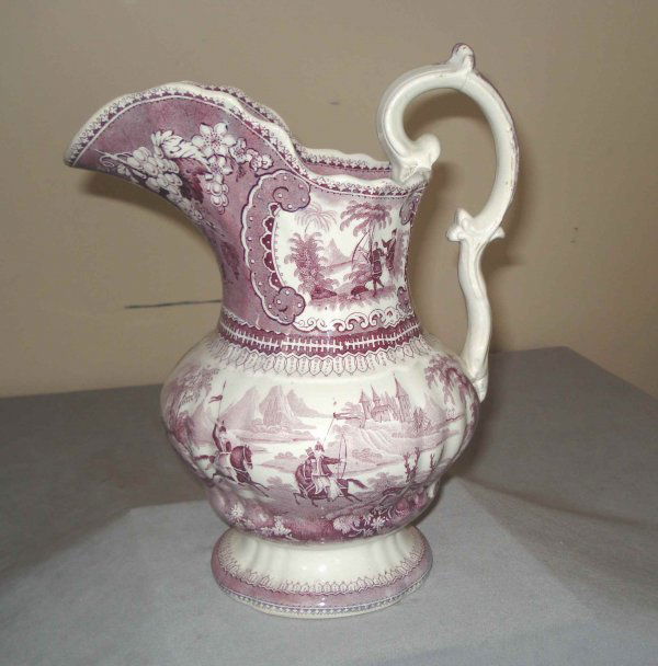 19th Century transfer ware pitcher: A 19th century transfer ware pitcher with a purple glaze, 11" in height. The wine or milk pitcher shows Persians hunting deer with bow and arrows in exotic lands.