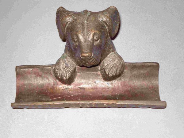 Dog pen holder: A reproduction of a 19th century casting of a dog theme pen and pencil holder.