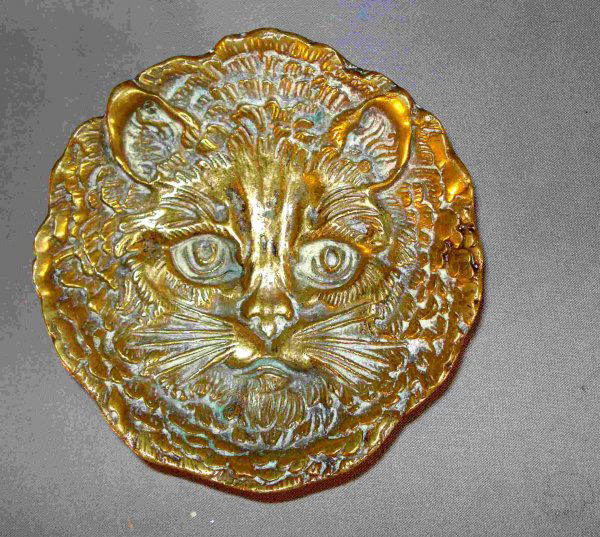 A cast brass Cat form pin holder: A nicely cast about 5" round brass pin holder with three legs and stamped "Bruges" on the back with the most amazing face of a cat.