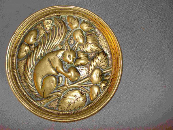 Squirrel: An antique pin holder or coaster of solid brass with a squirrel, about 5" in diameter.