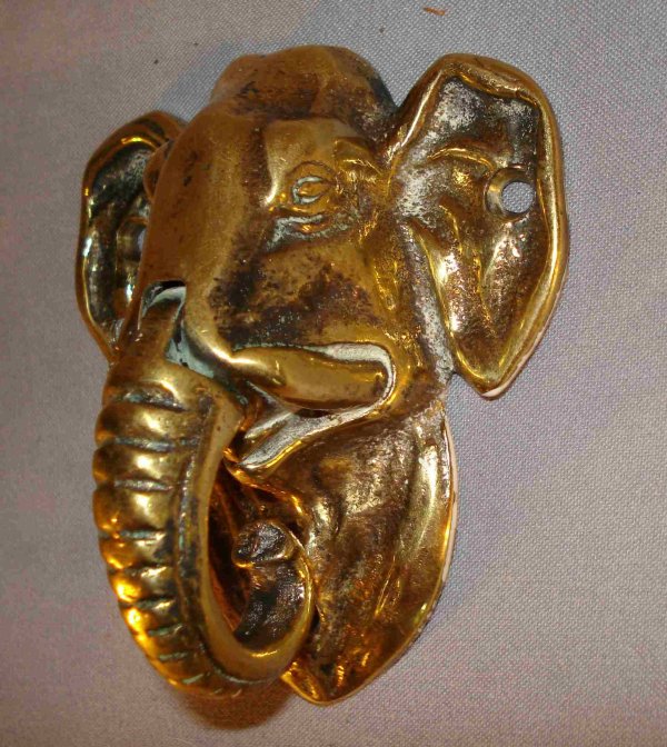 Elephant knocker: An antique solid brass door knocker, about 4 1/4", that may be mounted on interior door. This an elephant's head in solid brass.