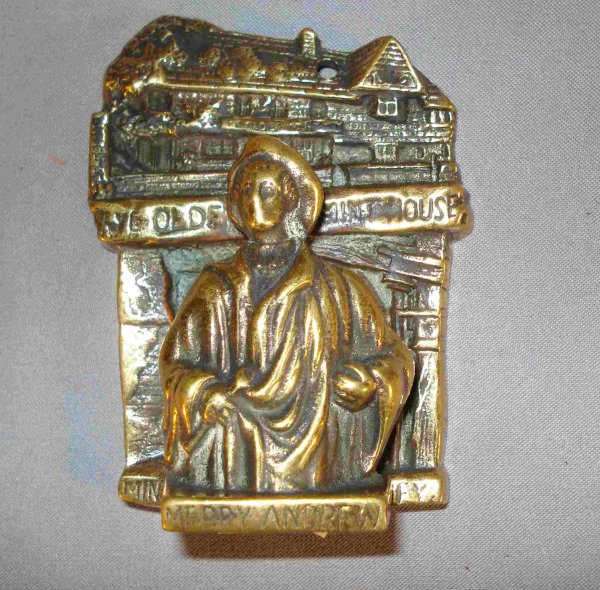 Brass door knocker: Merry Andrew: An antique solid brass door knocker, about 4 1/4", that may be mounted on an interior door. This solid brass door knocker Merry Andrew of Ye Olde Mint house.