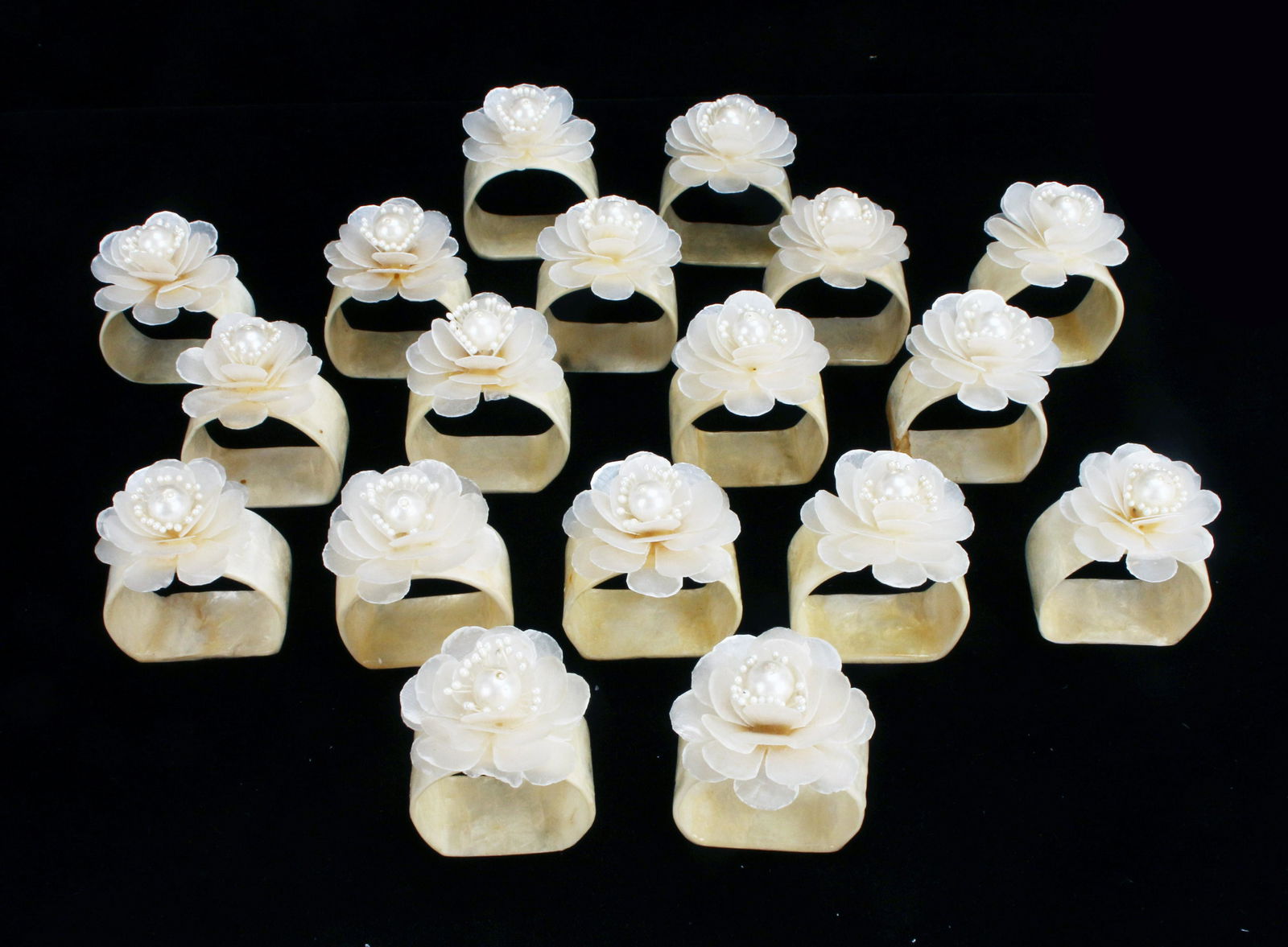 18 MOTHER OF PEARL FLOWER NAPKIN RINGS: 18 MOTHER OF PEARL FLOWER NAPKIN RINGS Mother of pearl napkin rings with flowers. Perfect for a wedding shower! Some petals are missing- see photos. 2&q