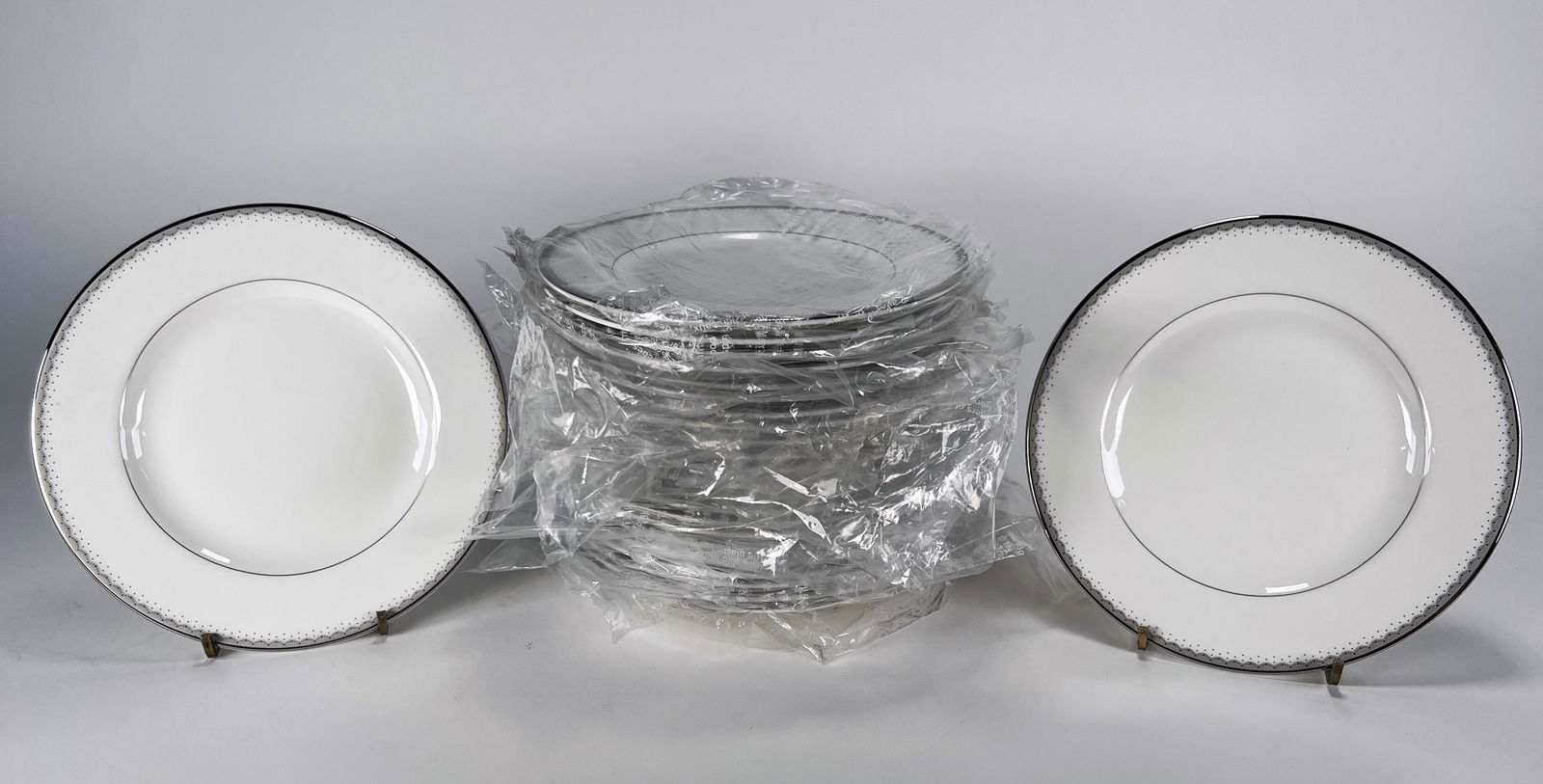 WATERFORD DENTELLE BREAD & BUTTER PLATES: WATERFORD DENTELLE BREAD & BUTTER PLATES 24 plates in white with silver accents. Marked Monique Lhuillier Dentelle Fine Bone China on back. 6 3/4"