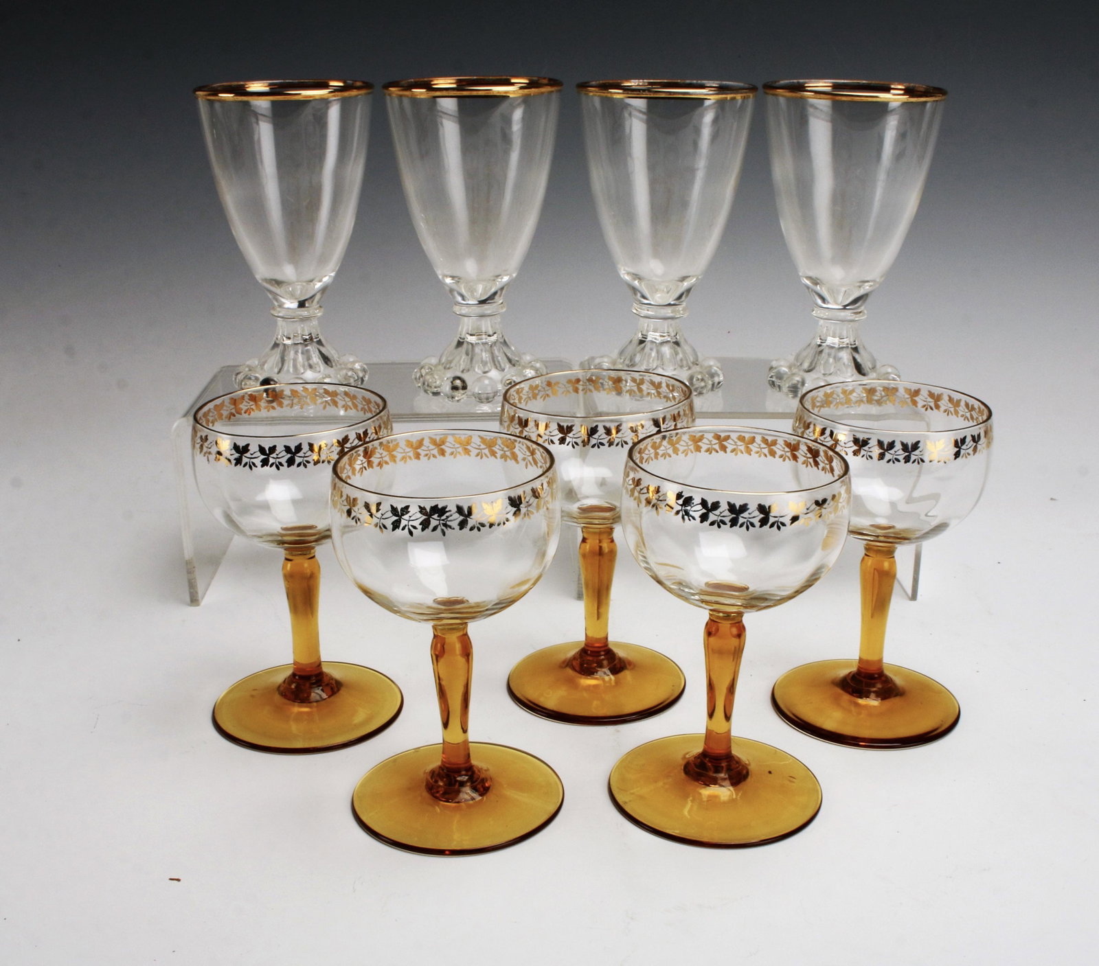 VINTAGE AMBER & GOLD CORDIAL & HOBNAIL WINE GLASSES: VINTAGE AMBER & GOLD CORDIAL & HOBNAIL WINE GLASSES 5 amber stem with gold designs on the bowl cordial glasses, and 4 clear glass with hobnail foot border and gold band