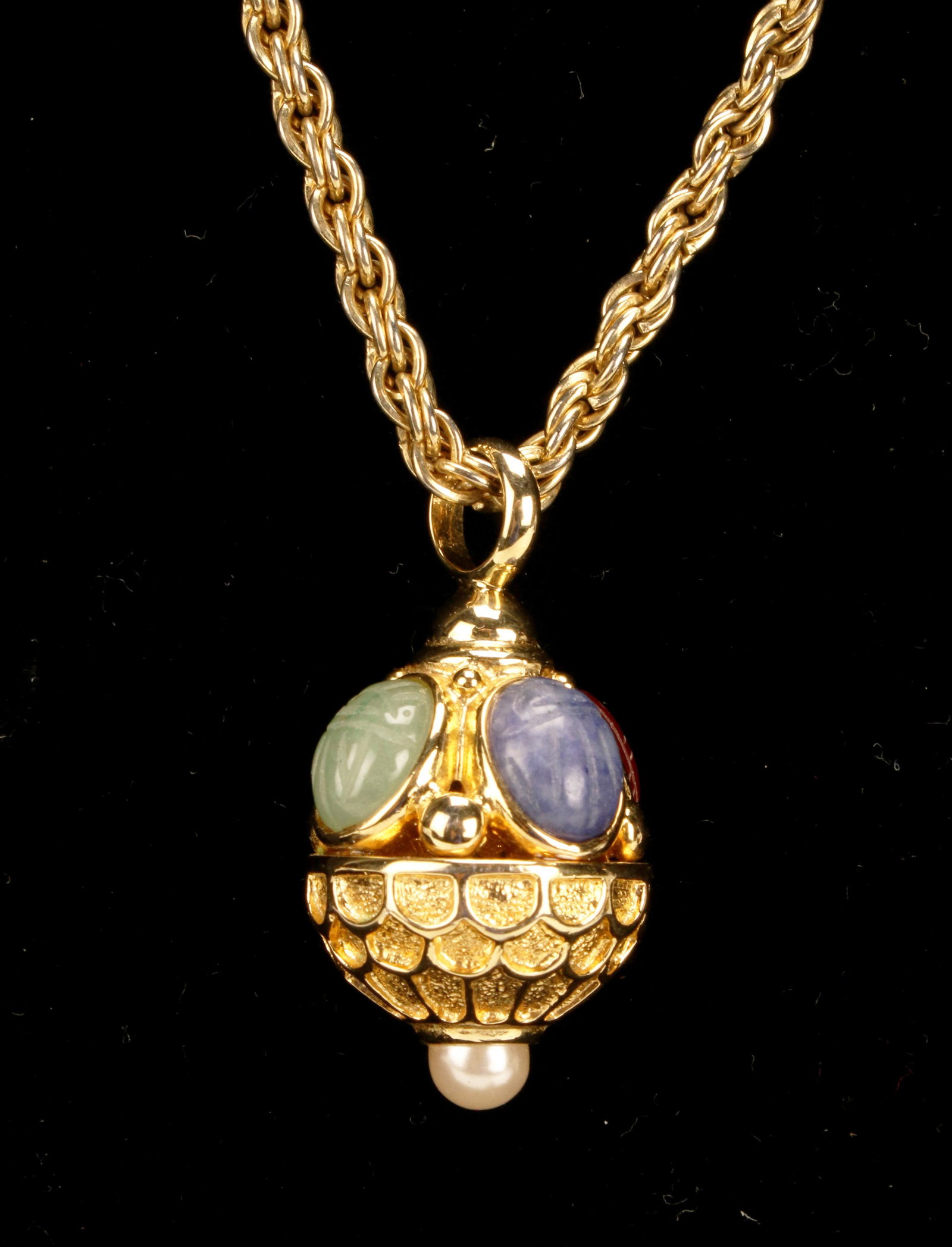 BALL PENDANT ON ROPE CHAIN SCARAB NECKLACE: BALL PENDANT ON ROPE CHAIN SCARAB NECKLACE Vintage gold tone ball pendant on 24" long rope chain. Pendant is bezel set with Carved carnelian, sodalite, jade and tiger eye scarabs. A