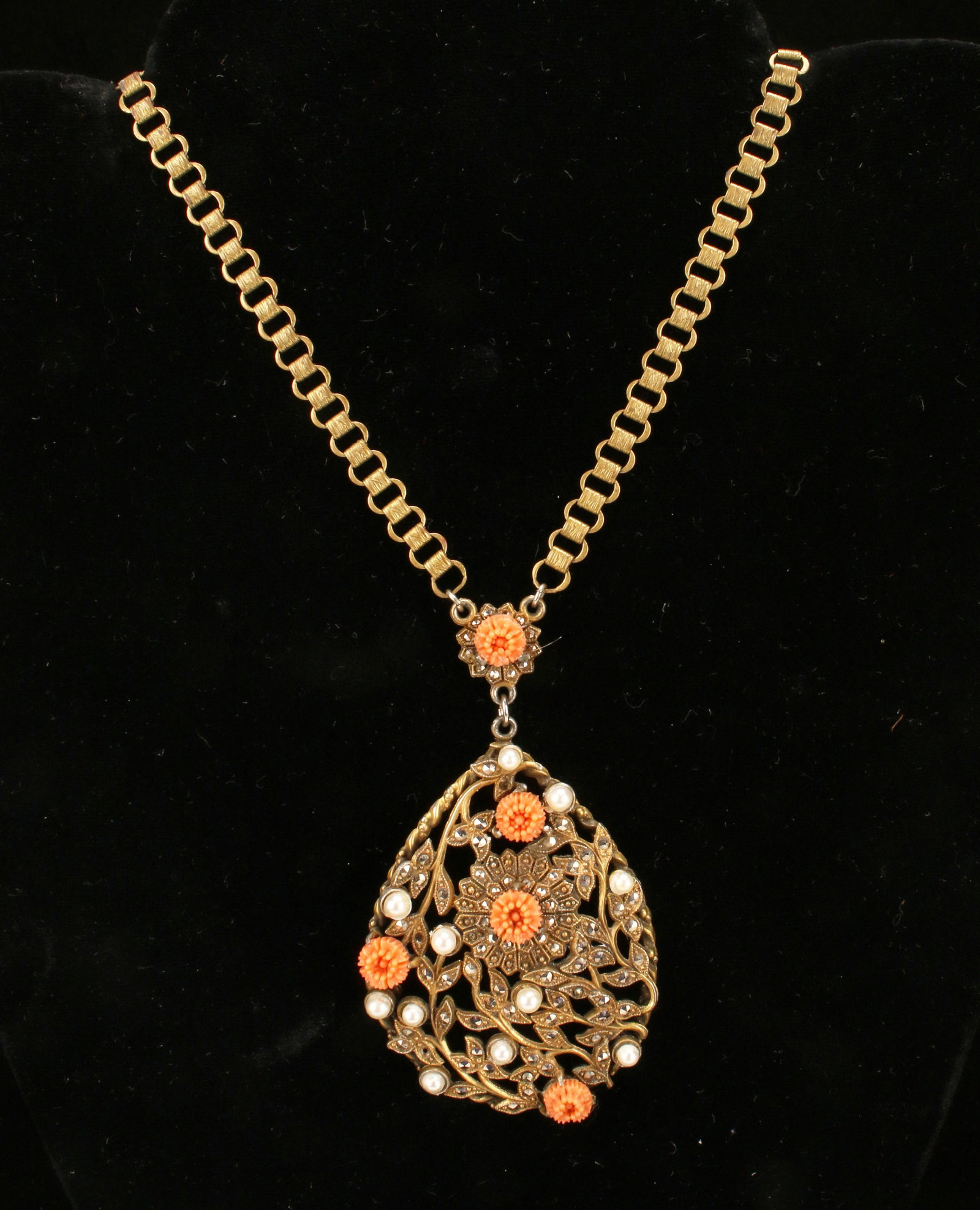 VINTAGE BOOKCHAIN MARCASITE PEARL CORAL COSTUME: VINTAGE BOOKCHAIN MARCASITE PEARL CORAL COSTUME Spectacular vintage pendant on attached bookchain. Gold tone in floral and tendril designs in teardrop shape. Accented in faceted Marcasit