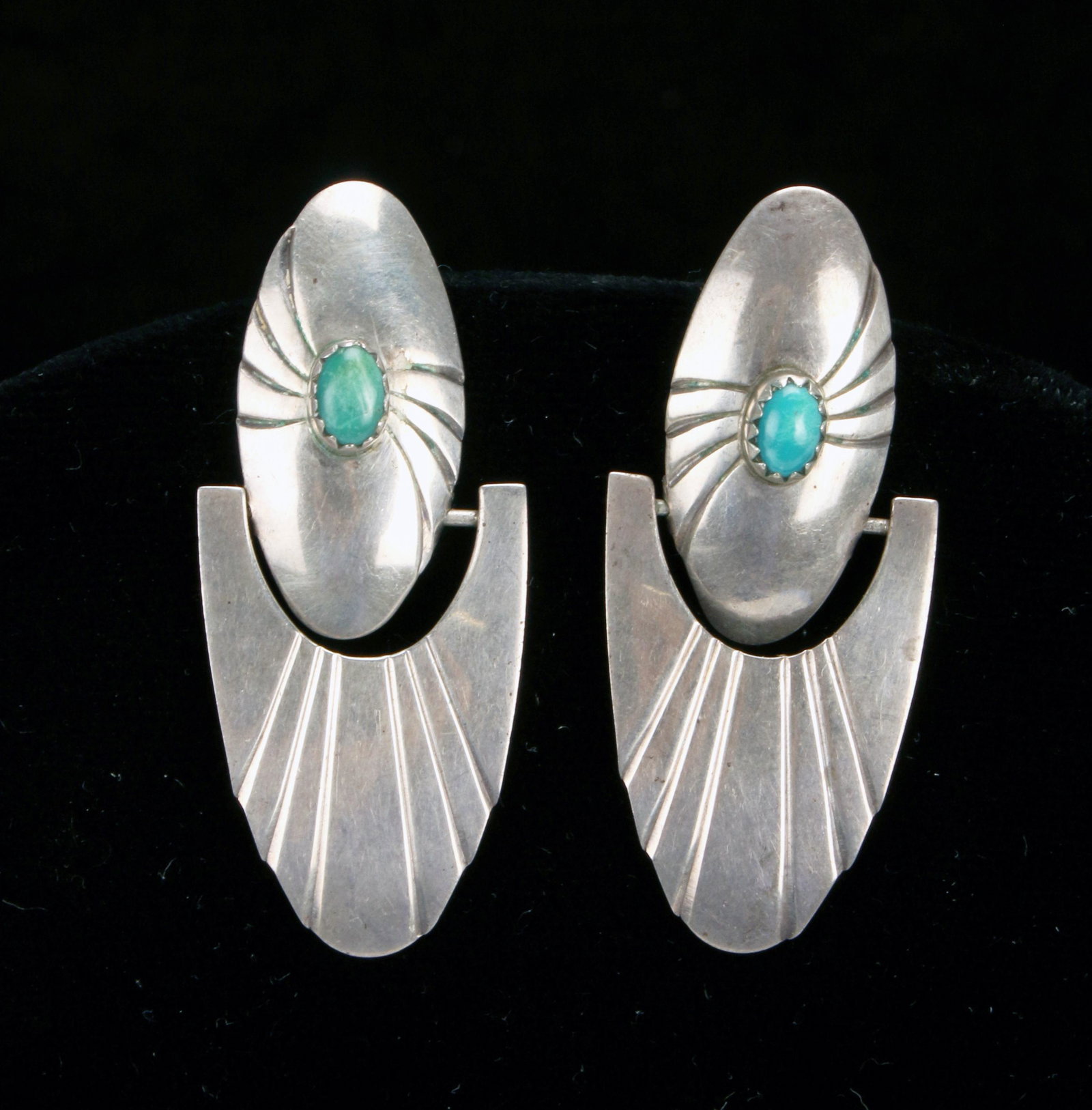 JOHN HOSKIE NAVAJO STERLING & TURQUOISE EARRINGS: JOHN HOSKIE NAVAJO STERLING & TURQUOISE EARRINGS Incised ovals with prong set cabochon turquoise sit on the ear and arc shaped drops swing from horizontal rods. Signed John Hoskie S