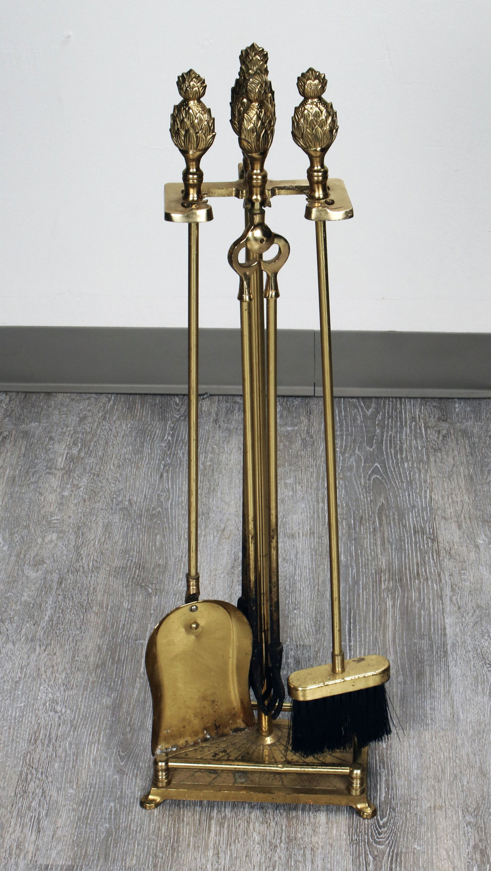 BRASS FIREPLACE TOOLS ON STAND: BRASS FIREPLACE TOOLS ON STAND Tongs, poker, shovel, and brush with pineapple finials. 9 1/2" X 28" Shipping: