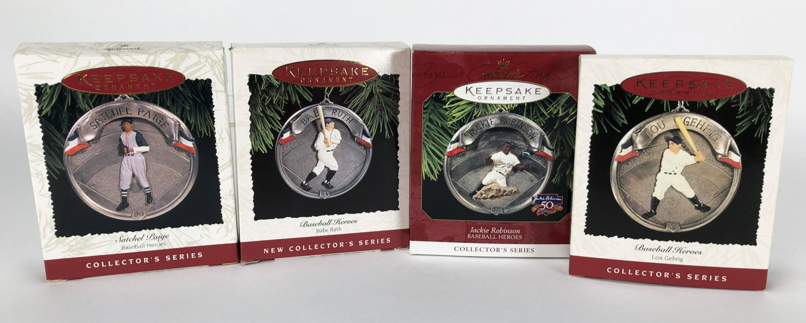 FOUR HALLMARK KEEPSAKE BASEBALL HEROES ORNAMENTS IN BOX: FOUR HALLMARK KEEPSAKE BASEBALL HEROES ORNAMENTS IN BOX Including Babe Ruth, Lou Gehrig, Jackie Robinson, Satchel Paige. 3 3/4" X 4 5/8"