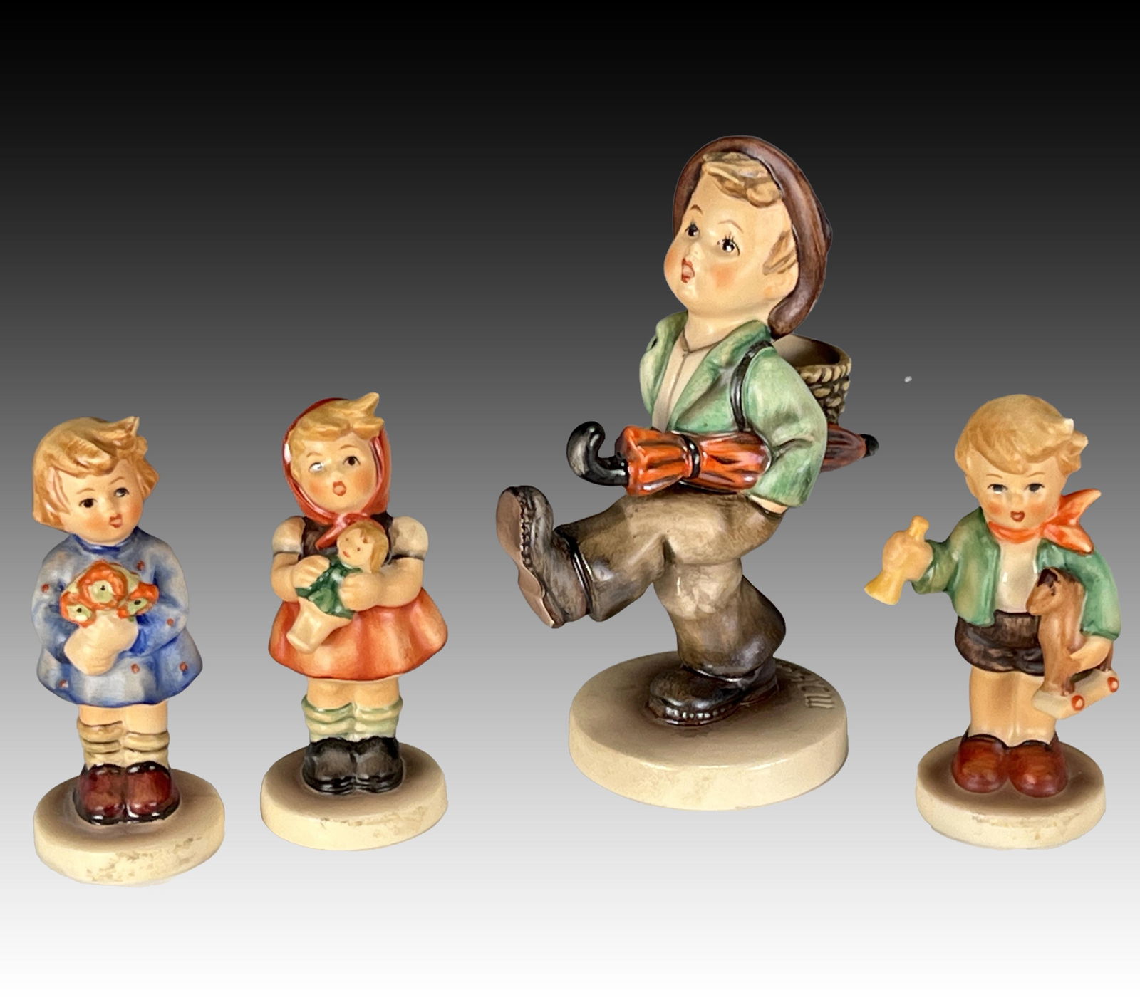 FOUR GOEBEL HUMMELS TMK-5: FOUR GOEBEL HUMMELS TMK-5 Includes Globe Trotter 79 TMK-5. Girl with Nosegay 239/A TMK-5. Girl with Doll 239/B TMK-5. Boy with Rocking Horse Toy 239/C TMK-5.