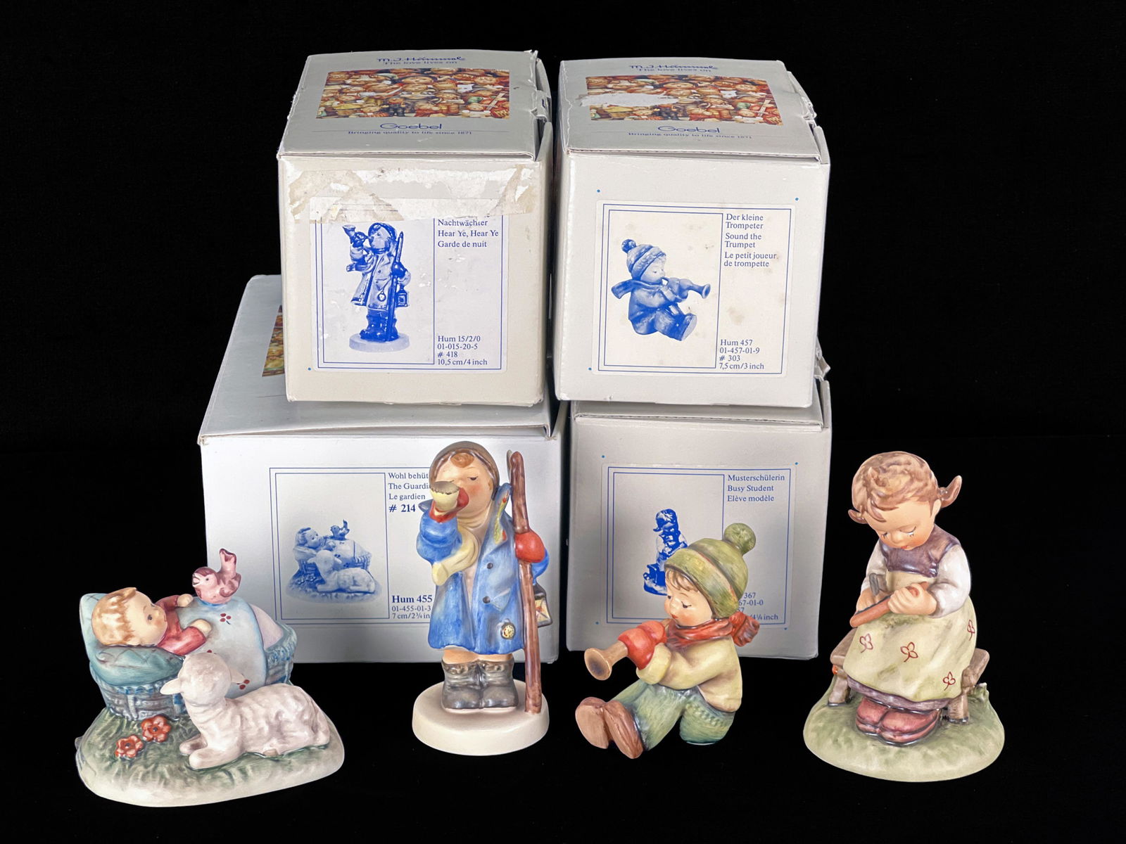 FOUR GOEBEL HUMMELS IN BOX TMK-6: FOUR GOEBEL HUMMELS IN BOX TMK-6 Busy Student, Hear Ye Hear Ye, Sound the Trumpet, and The Guardian. 5" X 3 3/4" X 7 1/2" <