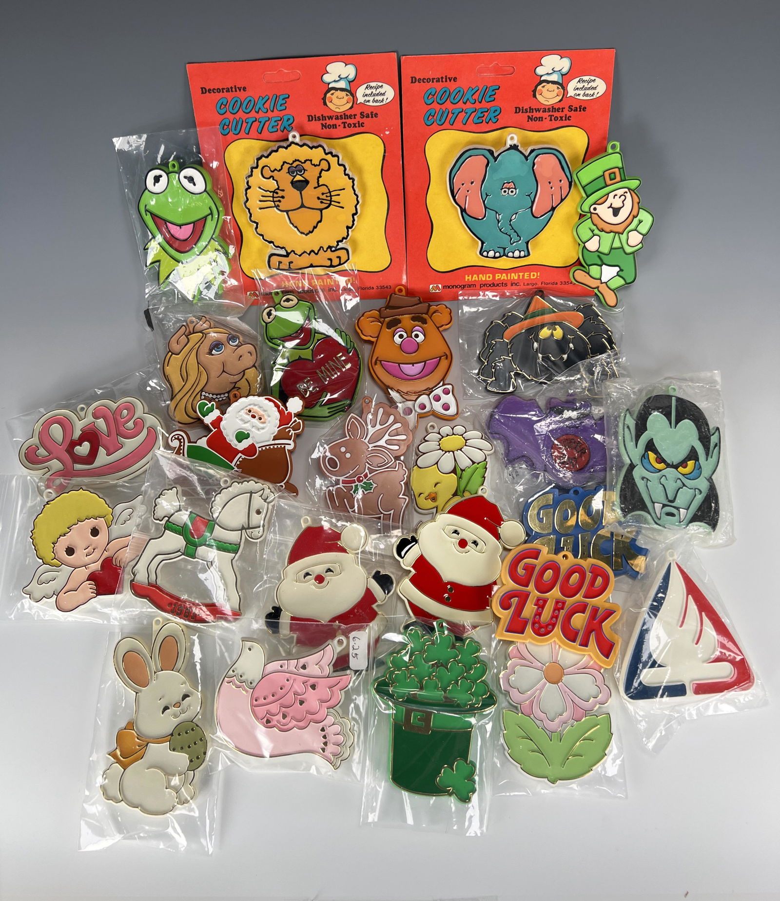LOT OF HAND PAINTED COOKIE CUTTERS: LOT OF HAND PAINTED COOKIE CUTTERS Many holiday themes, Kermit the Frog, animals, and more. Two in package. 5 3/4" X 7" Shi