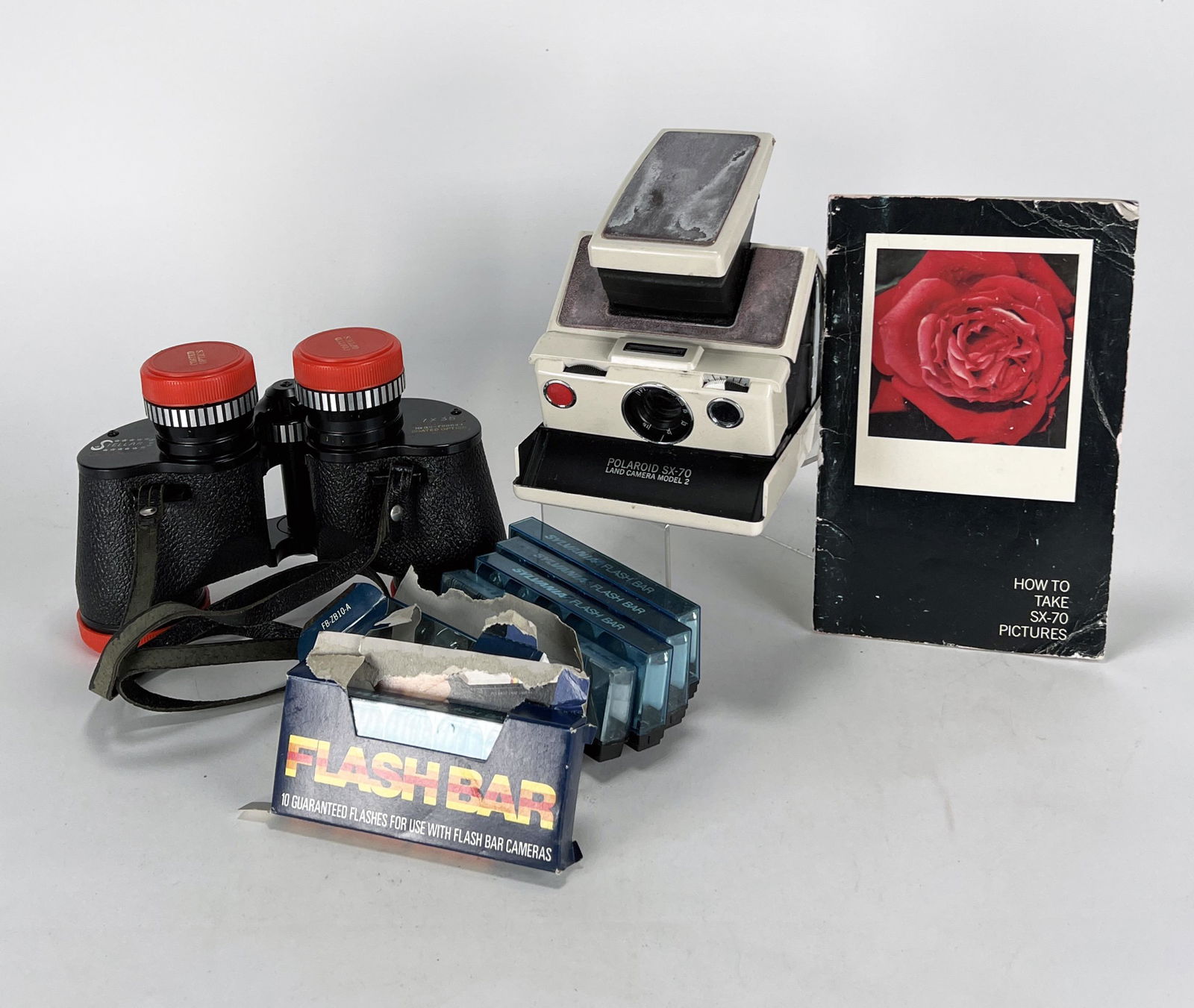 STELLAR BINOCULARS & POLAROID LAND CAMERA: STELLAR BINOCULARS & POLAROID LAND CAMERA Stellar Famous Precision 7X35 coated optics extra wide angle binoculars in Stellar leather case with strap. Polaroid SX-70 Land Camera Model