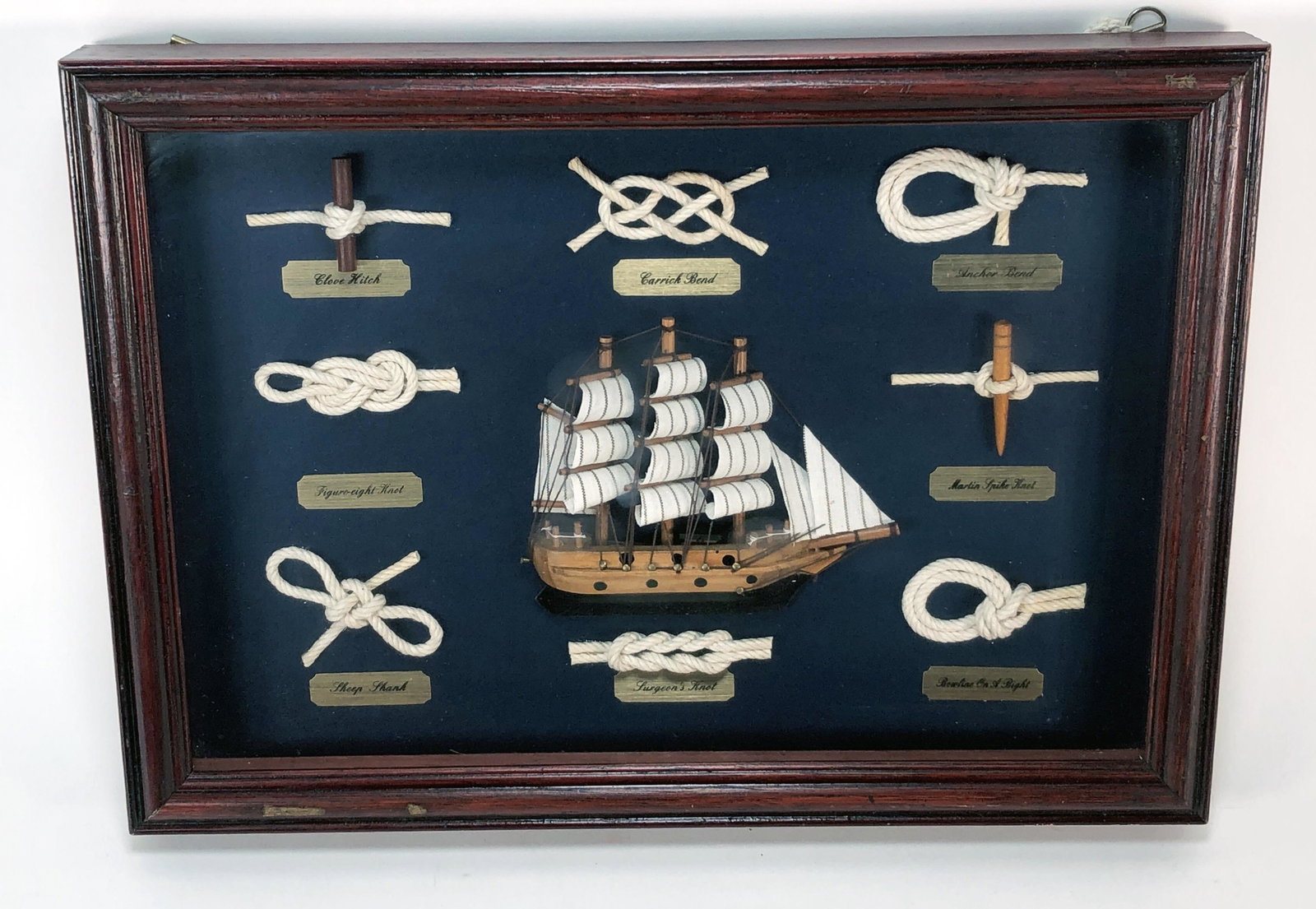 SHIP KNOTTING WALL HANGING: SHIP KNOTTING WALL HANGING Shadowbox framed examples of ship knots, perfect for any boating enthusiast's home. 13 3/4" X 10"