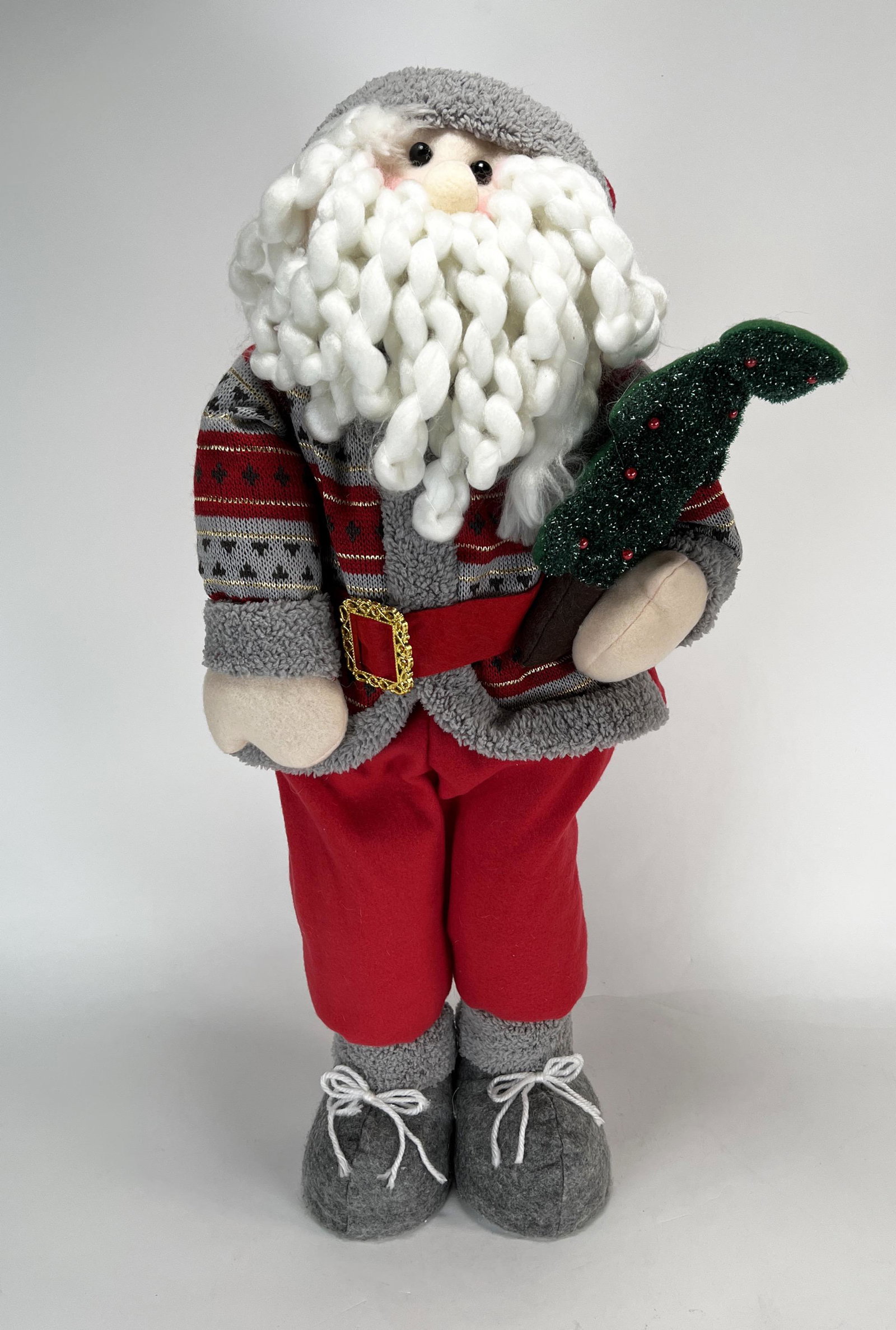 STANDING PLUSH YARN SANTA: STANDING PLUSH YARN SANTA Decorative Santa is wearing a wooly cap and sweater and is carrying a decorated tree. Free standing and can be placed in doorways, on the floor or on a table.