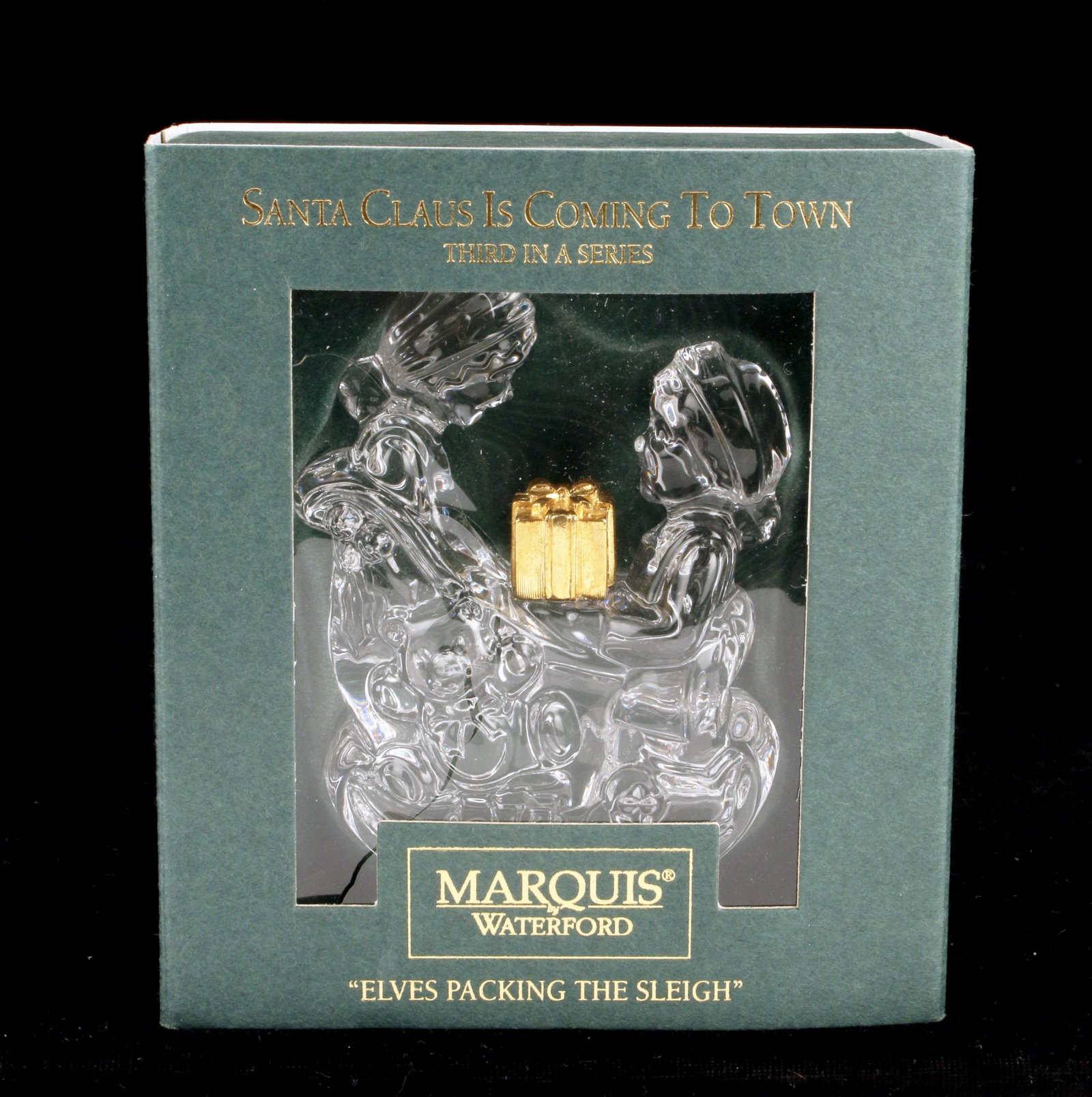 WATERFORD MARQUIS ELVES PACKING SLEIGH ORNAMENT IN BOX: WATERFORD MARQUIS ELVES PACKING SLEIGH ORNAMENT IN BOX Marquis by Waterford Santa Claus is Coming to Town third in series "Elves Packing the Sleigh" ornament in box. Rip in pla