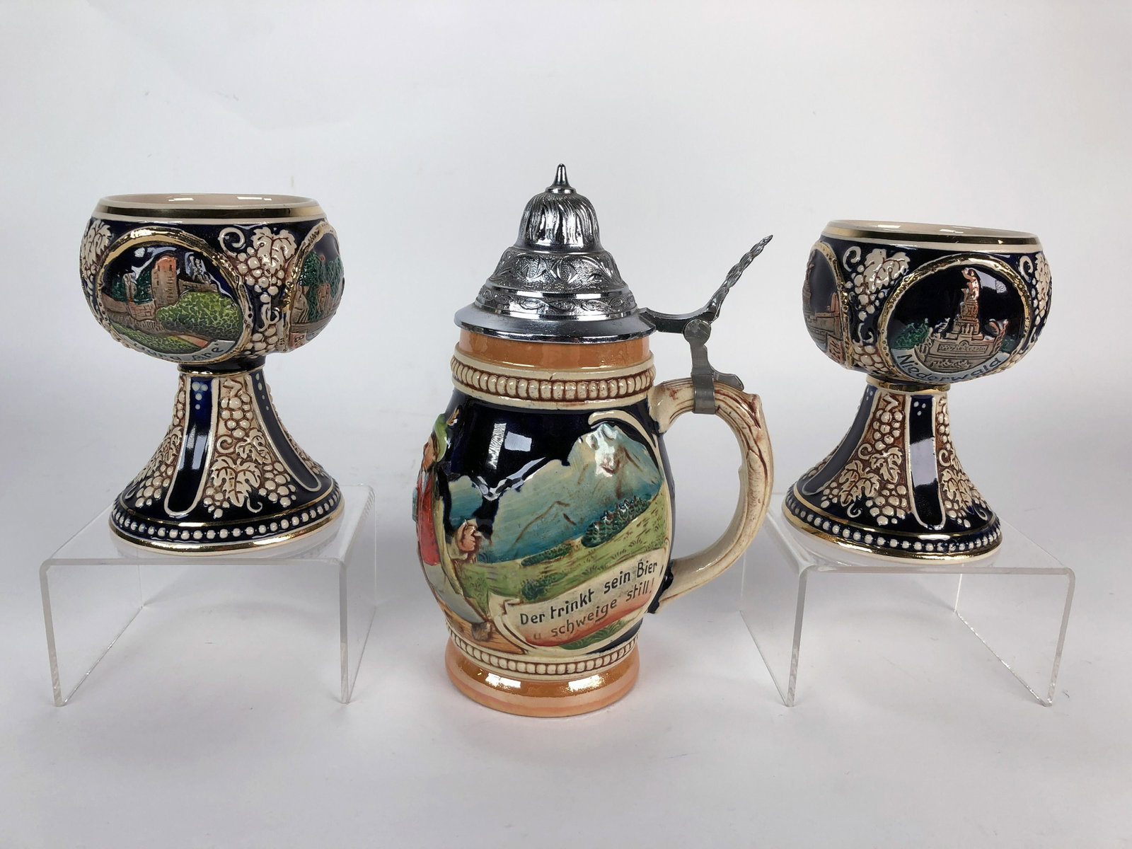 GERMAN BEER STEIN & TWO WINE GOBLETS: GERMAN BEER STEIN & TWO WINE GOBLETS Two German wine goblets decorated with circular reserves of German cities on a cobalt ground. Both marked Made in Germany. One German beer stein