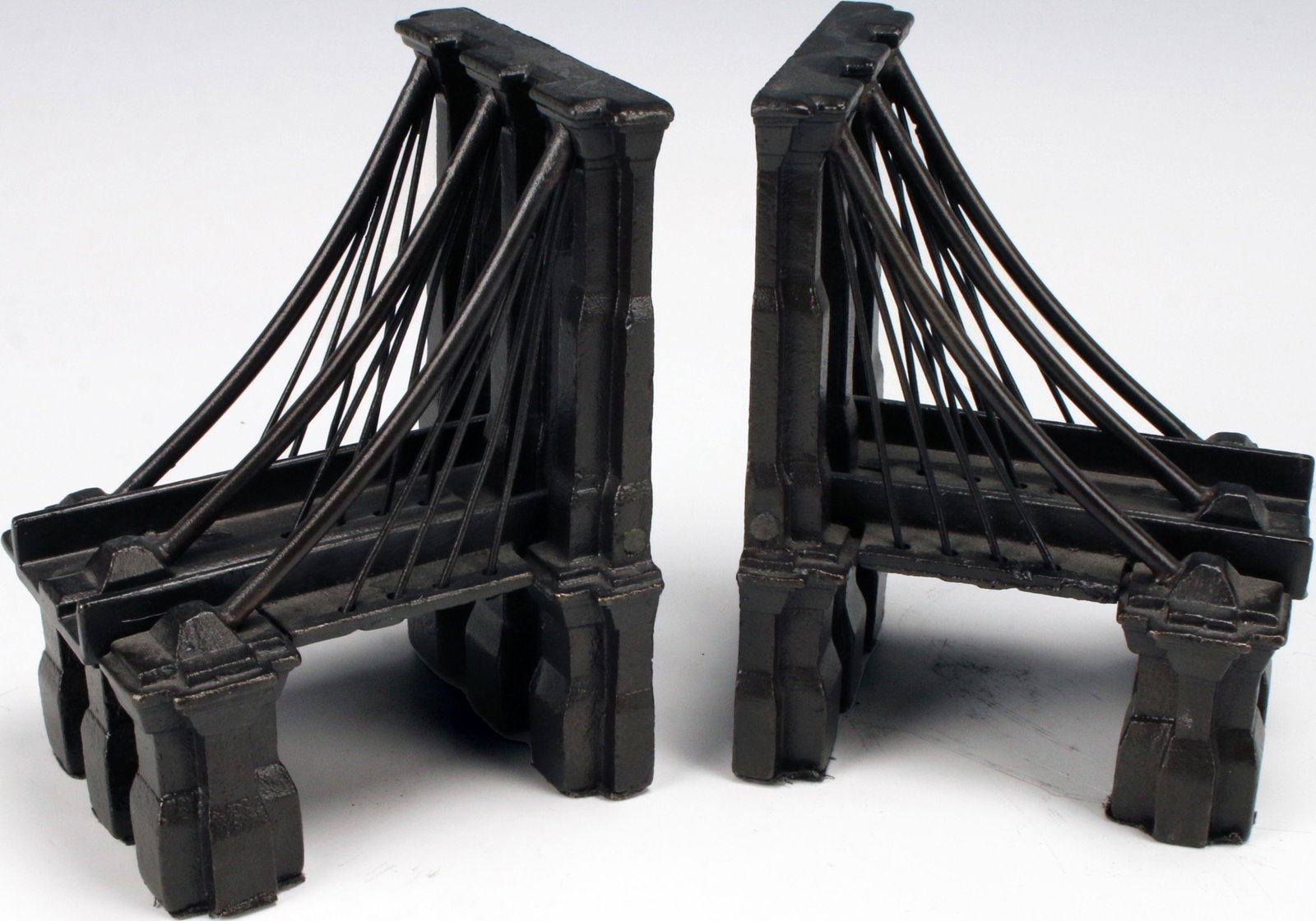 RESTORATION HARDWARE BROOKLYN BRIDGE BOOKENDS: RESTORATION HARDWARE BROOKLYN BRIDGE BOOKENDS Bookends depicting the iconic Brooklyn Bridge. Marked Restoration Hardware on the bottom. 4 1/4" X 3 3/4