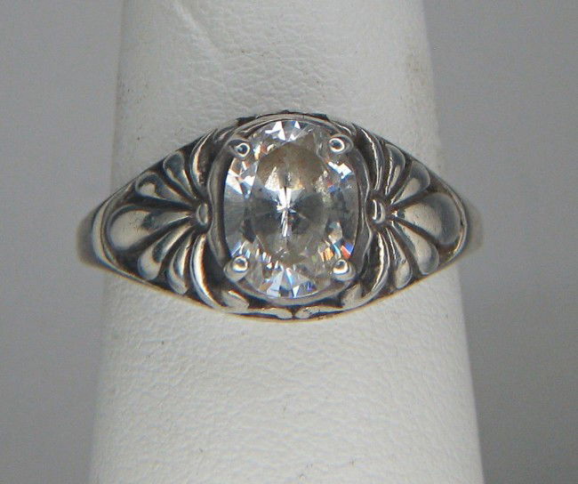 Diamond ring: A .925 silver ring mounted with oval shaped diamond, 13.7 mm in height.