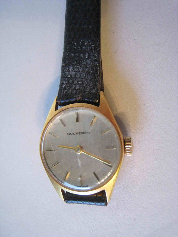 Bucherer wrist watch: An 18K gold wrist watch signed "Bucherer" on the dial. The crystal has an imperfection at 11:00.