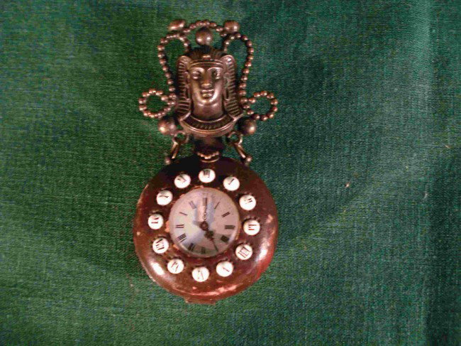 Leather, brass and porcelain watch holder: A tooled leather and bronze pendant watch or belt watch Chatelaine mounted with small round porcelain numerals , now with a watch installed.