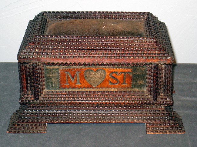 Tramp art of folk art sewing box: A chip carved or "tramp art" sewing box, 6" X 1 1/4" X 7 1/2" This undisturbed artifact is obviously hand made, with the plaque mounted on the front "M [heart] ST" and we wonder if this does not mean 