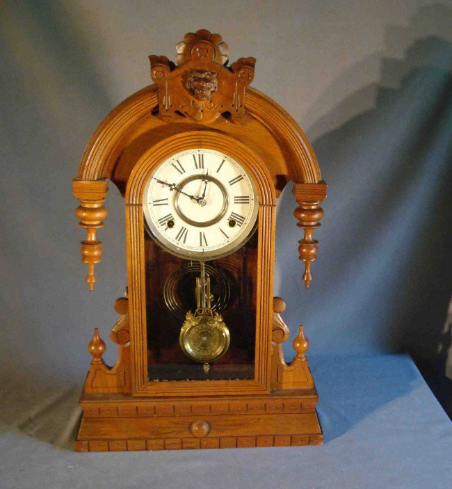 Walnut shelf clock: A walnut cased shelf clock whose damaged label verso suggests the purveyors to have been the Boyle brothers of Boston. Features an arched top case style with tear drop finials and calibrated pendulum.
