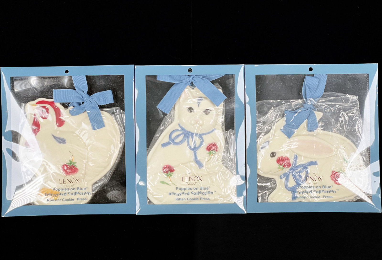THREE LENOX COOKIE PRESSES IN PACKAGING: THREE LENOX COOKIE PRESSES IN PACKAGING From the Poppies on Blue Barnyard Collection: Kitten, Rooster, and Bunny. All in original Lenox packaging. 5 1/2&qu
