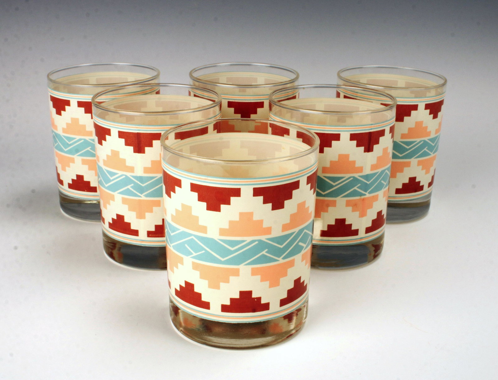 SIX SOUTHWEST STYLE TUMBLERS GLASSES: SIX SOUTHWEST STYLE TUMBLERS GLASSES Six glass tumblers with a southwest style flare. 4 1/4 x 3 1/4" Shipping: