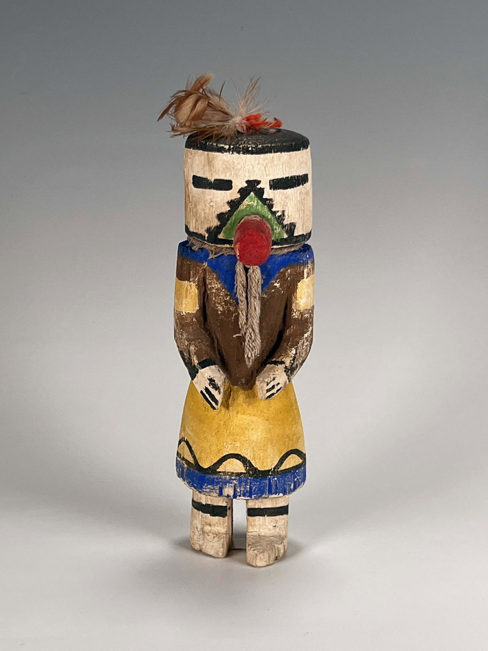 KACHINA DOLL: KACHINA DOLL With cylindrical head and yellow skirt. Kachina dolls represent of