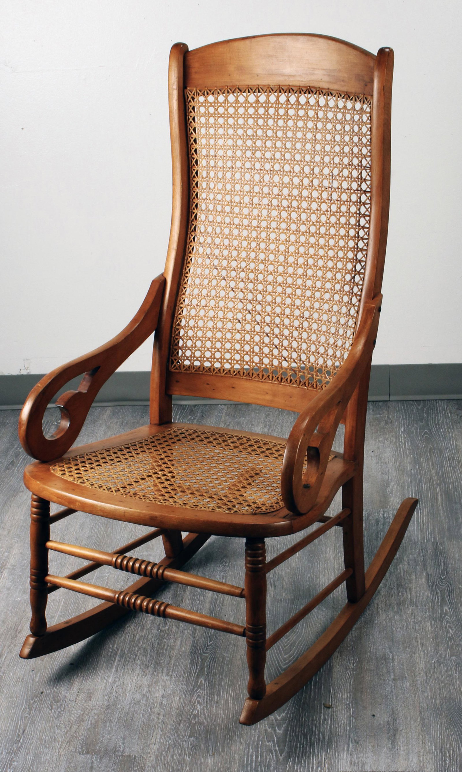 CANE SEAT & BACK ROCKING CHAIR: CANE SEAT & BACK ROCKING CHAIR Rocking chair with shaped arms, cane seat and back. 20 1/4" X 32" X 42" Shipping: