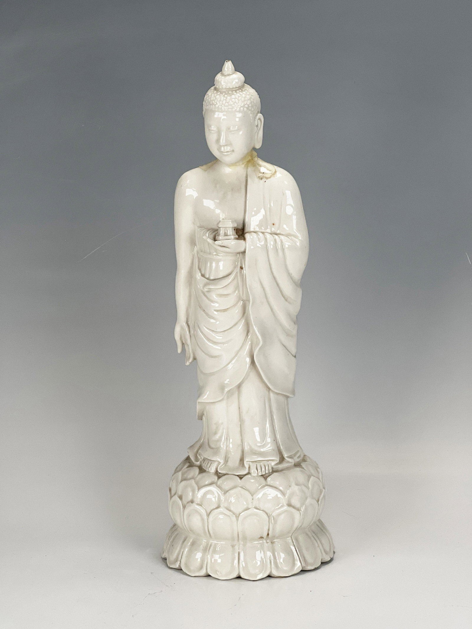 BLANC DE CHINE FIGURE: BLANC DE CHINE FIGURE Temple in hand is broken, neck has been repaired 12 1/4" Shipping: Shipping and