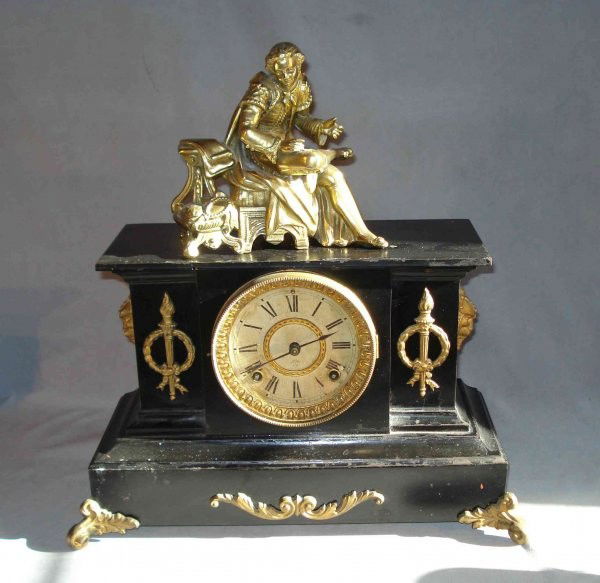 Ansonia Mantel Clock: An ebonized cased mantel clock by Ansonia mounted with a bronze figure of cast bronze.