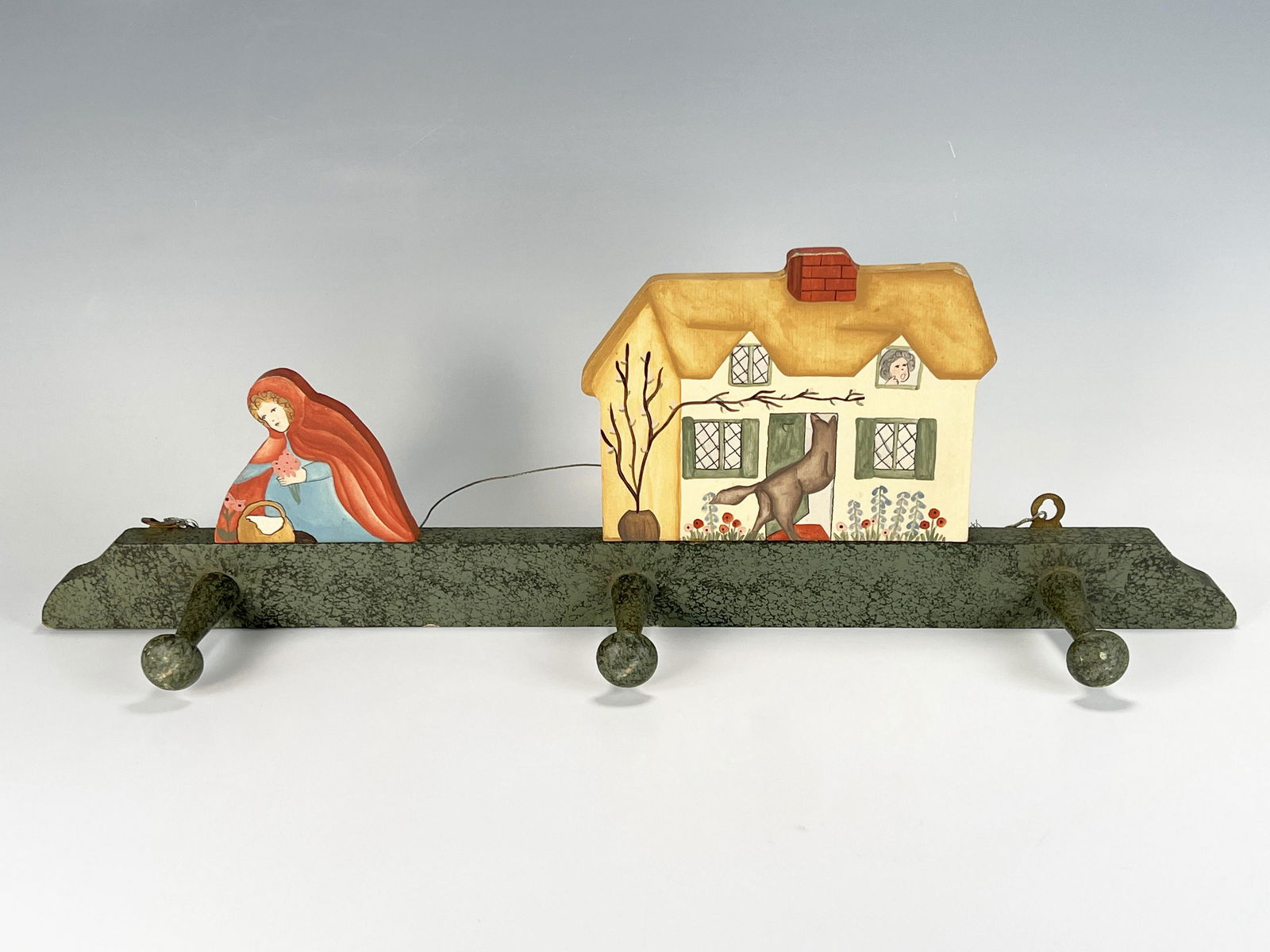 CHILDRENS LITTLE RED RIDING HOOD COAT RACK: CHILDRENS LITTLE RED RIDING HOOD COAT RACK Charming hand painted wood coat rack with the wolf entering grandma's house as Little Red Riding Hood picks flowers. Hand painted by "As G