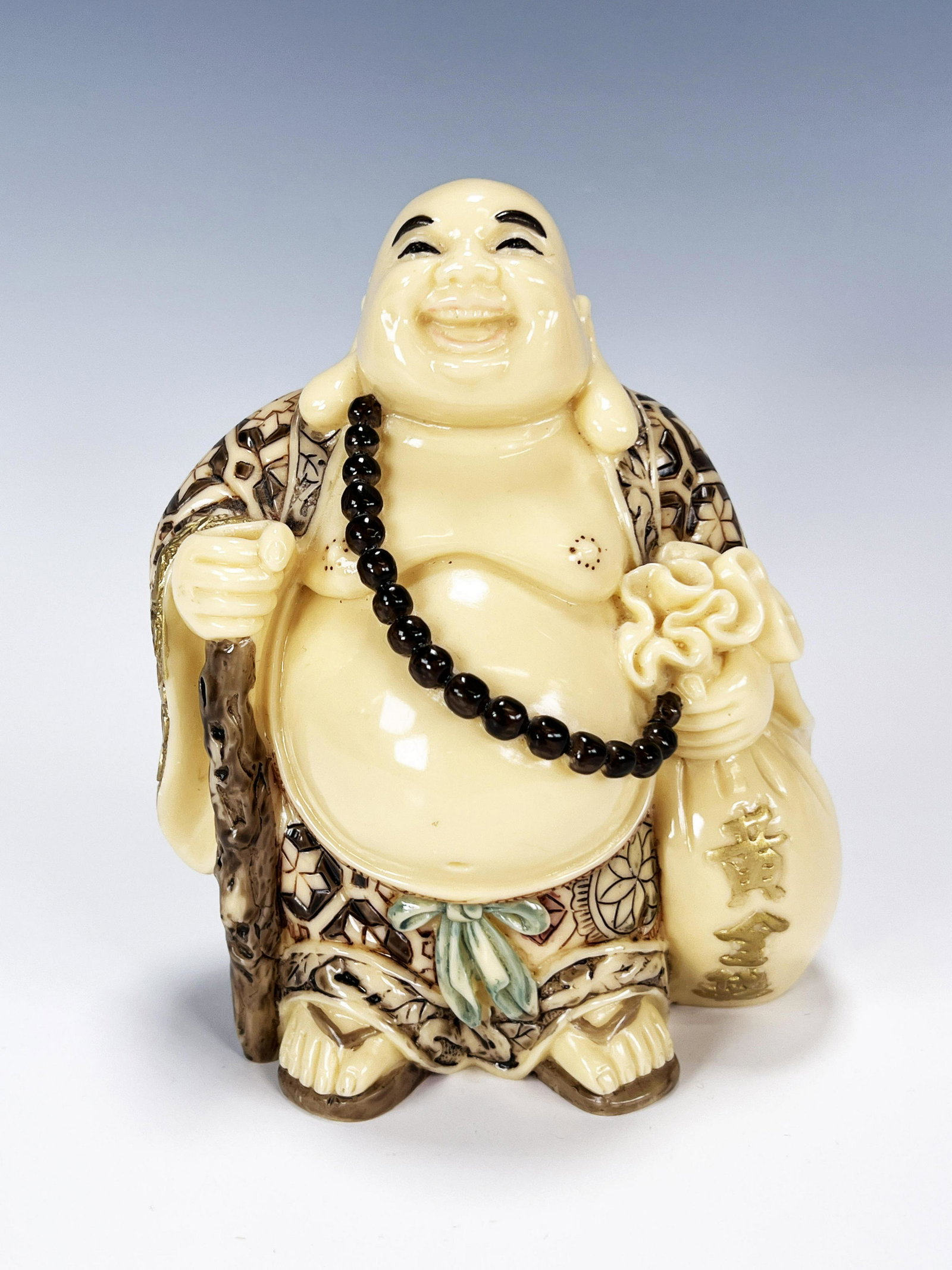 LAUGHING BUDDHA STATUE: LAUGHING BUDDHA STATUE Robed, but showing off his belly. Buddha cocks his head back in laughter while holding a sack at his side. Marked on the bottom. 4 1