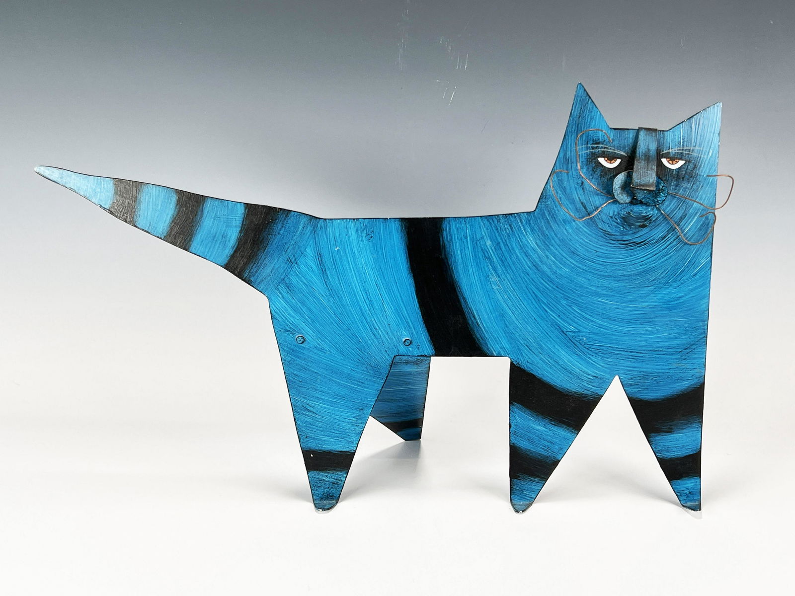 SERIOUS FACE METAL CAT STATUE: SERIOUS FACE METAL CAT STATUE This fun, turquoise and black cat is reminding you that it is time to pet or feed it, with all the seriousness of any domestic feline.