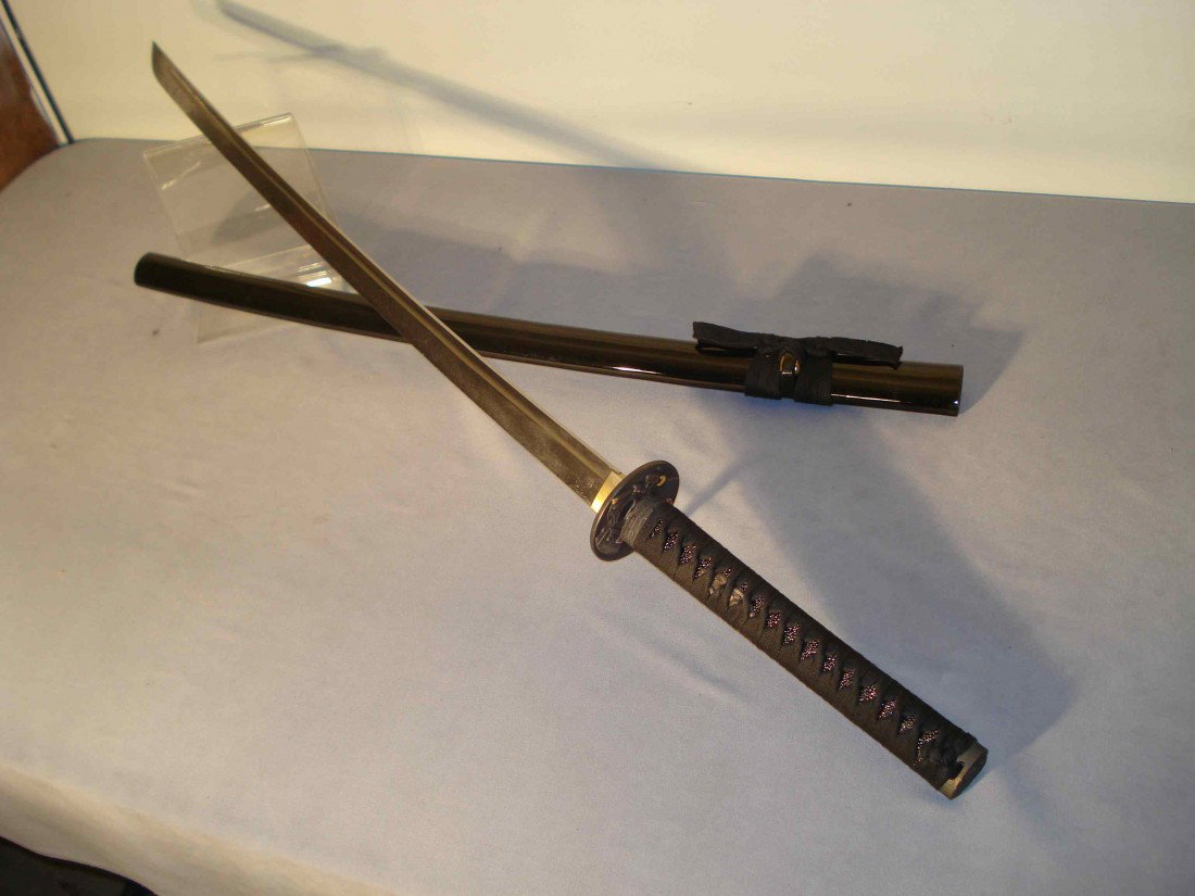 Samurai Sword: A modern samurai sword and scabbard. The 39 1/2" sword has a 28" polished steel blade with an ebonized wood scabbard.