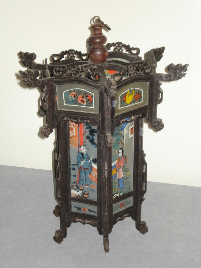 Reverse Painted Chinese Lantern: A remarkable Chinese lantern, possibly for hanging. The ebonized wood frame holds delicately reverse painted glass lenses between carefully carefully made panels. Apparently originally made for oil la