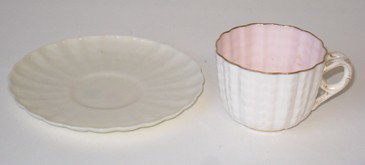 Demitasse Cup By Ott And Brewer: An demitasse cup with scalloped edge, gold decoration, and pink pearl like interior glaze, 2 1/4" in diameter (ca 1832-1892), matched with a 4 3/8" saucer with embossed exterior decoration. And an Ame