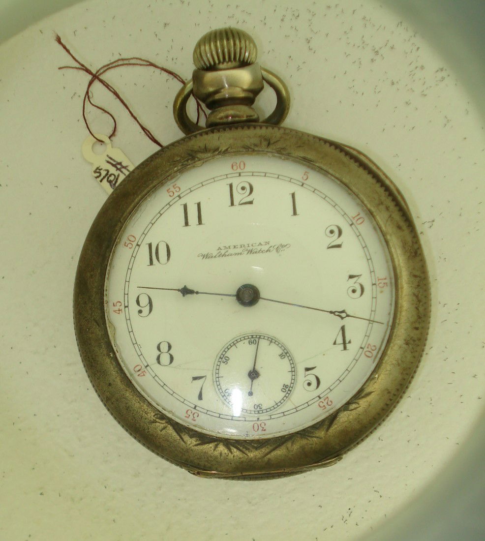 American Watch Company Watch: A watch by AWC in the 18 size open faced coin silver case, 57 mm in diameter and stem set.