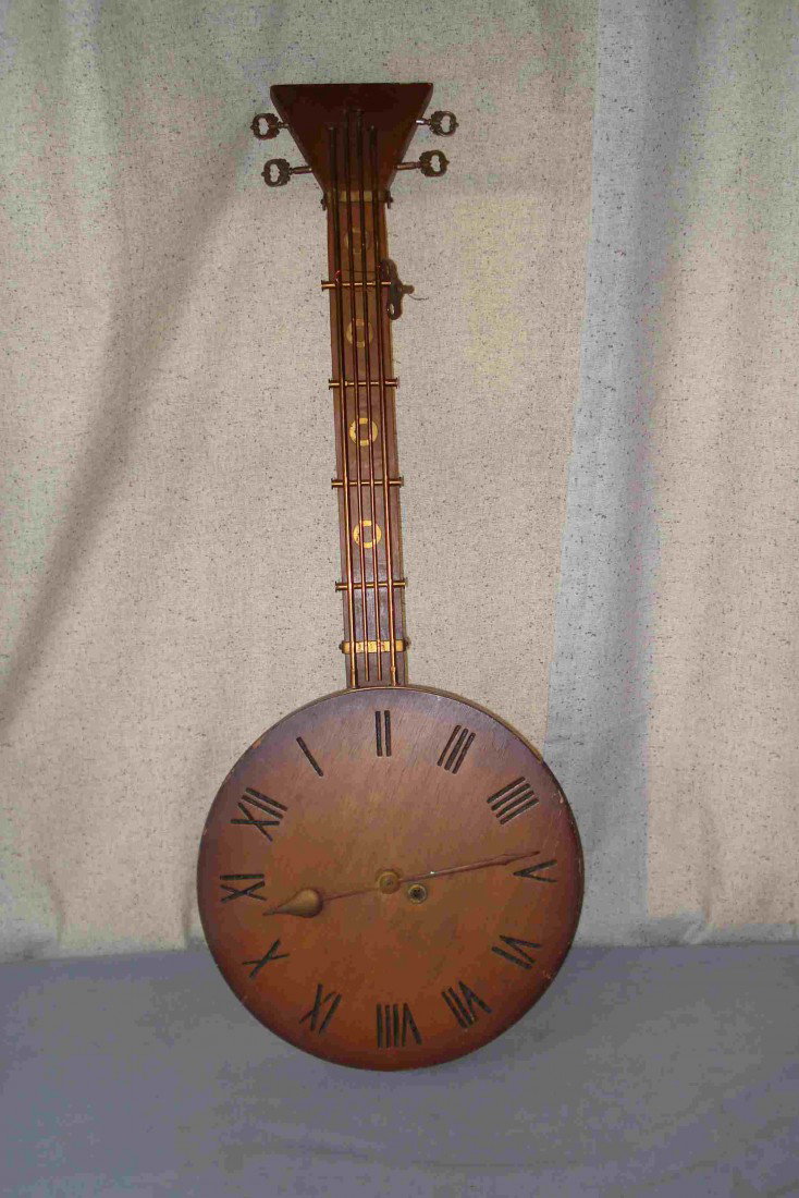 "Banjo" Clock: A 20th century vintage wood cased clock in the form of a banjo.