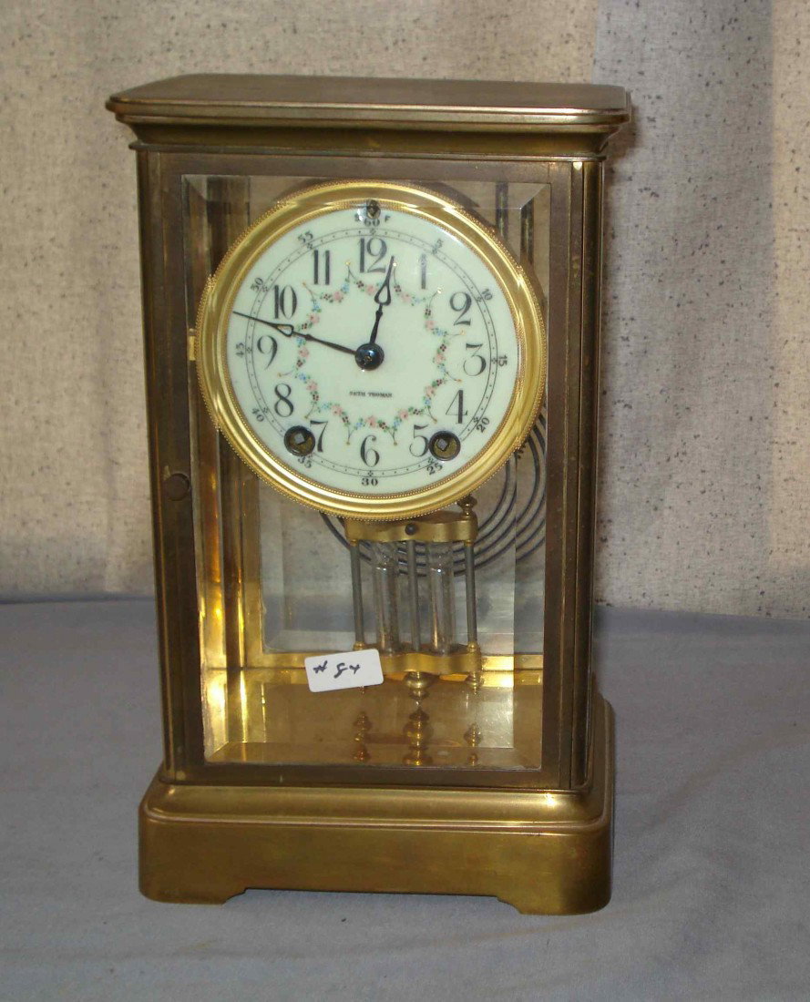 Seth Thomas Crystal Regulator: An American late 19th century clock with a brass and bevel glass case with a clock having a faux Mercury pendulum and a swag decorated dial.