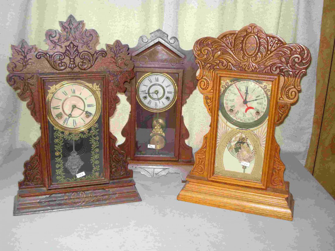 Three Ginger Bread Clocks: Two with pressed oak cases and having reverse decorated glasses.