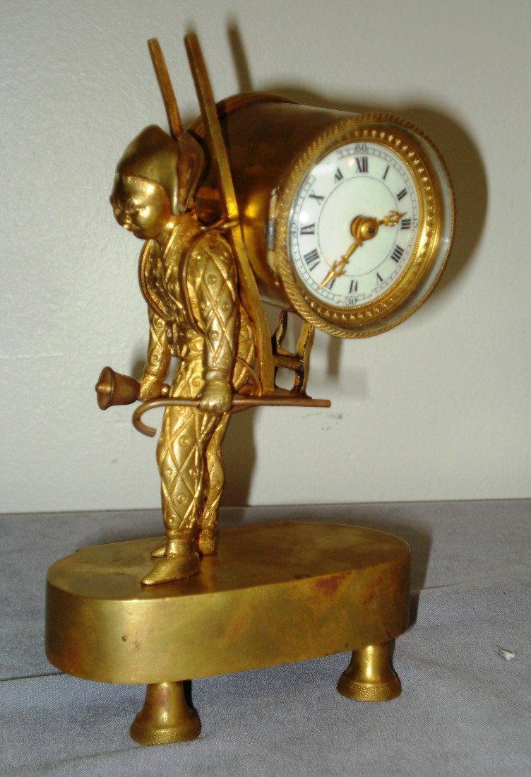 French Bronze Desk Clock: A late 19th century French made desk clock, a bronze dore casting of a an 18th century town watch man bearing a round dialed clock with an platform type escapement. 6 3/4" X 4 1/4" X 2 1/2".